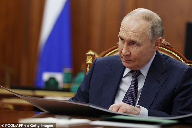 Vladimir Putin is pictured attending a meeting in Moscow on July 18