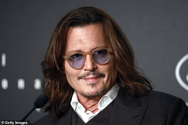 Johnny (above) drew a penis on top of a picture of Amber in a bikini... written on the mirrors in the bathrooms were disjointed phrases scrawled in black paint and blood