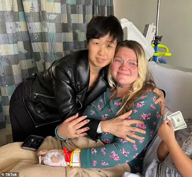 After the shock allegations made headlines this week, an image emerged showing Zhang smiling at the birth of one of the children, hugging surrogate mother Kayla Elliot, 27