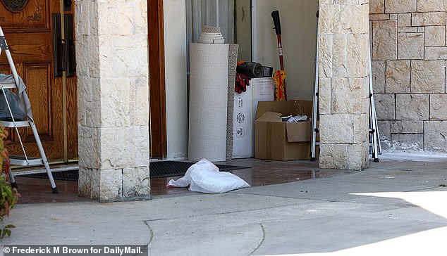 The mansion showed no signs of life this week as an assortment of trash and an SUV sat outside
