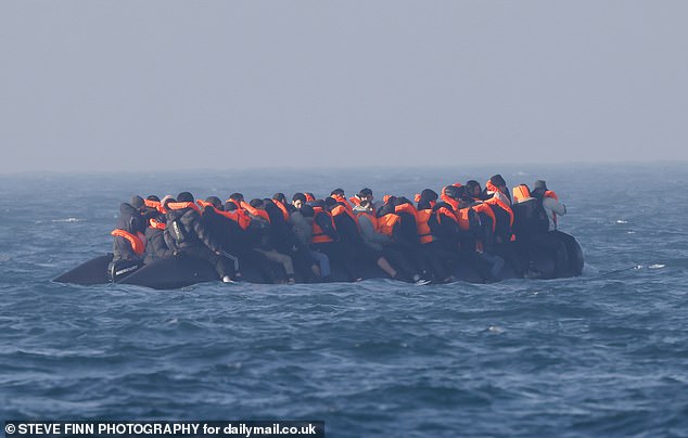 Migrants are seen on a small dinghy heading towards the UK (file photo)