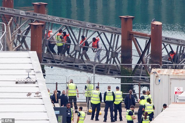 A group of people thought to be migrants are brought in to Dover, Kent, from a Border Force vessel on July 17 (file photo)