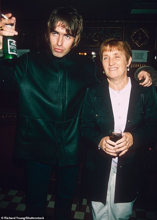 Liam, 52, and Noel, 58, are said to been 'kept apart' in 'military style operation' when not on stage, but now their mother is also on hand to help avoid a bust up (Liam and Peggy in 1998)