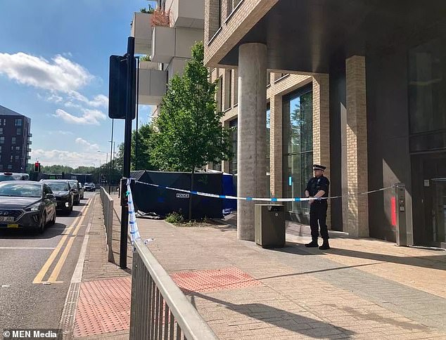 Police at the scene in Manchester where Ms O'Hare's body was discovered on the pavement next to an apartment complex, where she was living