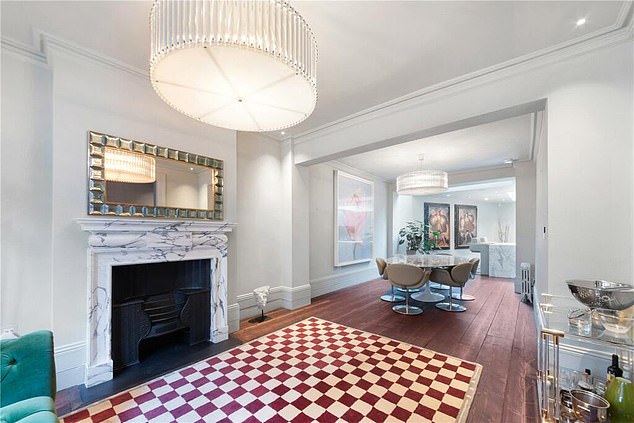 The interior of the home also boast an elegant tiled floor and grand marbled fire place