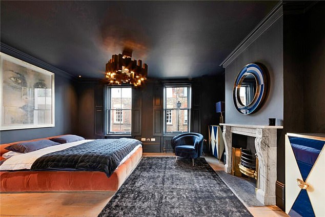 One of the bedrooms in the flat decorated with lavish furniture and a modern chandelier