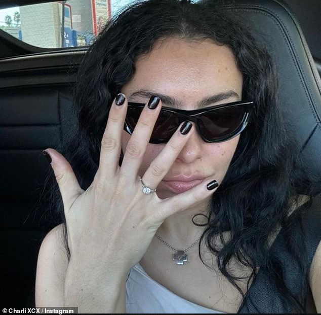 The band seemingly boasted a bold twisted, overlapping design and in platinum it perfectly matched her engagement ring (pictured) which is worth £15K