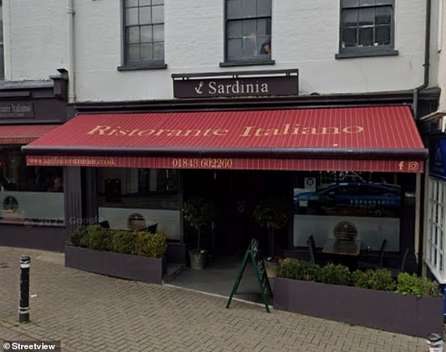 The yobs appeared to be storming an Italian restaurant, Sardinia, which is popular in the town
