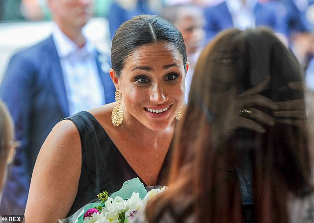 Meghan meets a well-wisher in Cape Town. Meghan's tendency to go off-script and rebel against the constraints of royal life were glaringly obvious during this royal tour