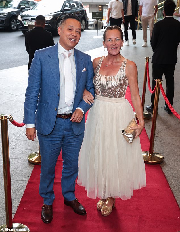 Lorraine attended the bash with her husband Mark Perez - who looked dapper in a blue marl tailored suit, with a white shirt and light pink satin tie