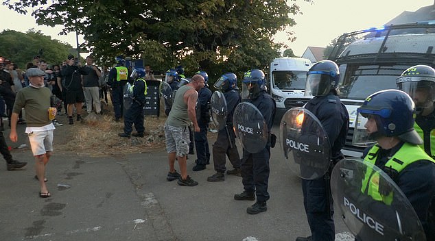 Other footage shows the man furiously shouting at the riot police after his teeth have been knocked out as the man filming comments 'he's fuming mate'