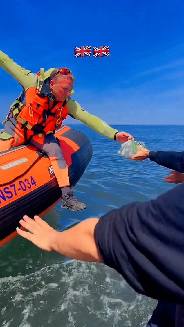 Shocking footage filmed by the migrant showed him on a small boat with around 20 other men being given bottles of water by the French coastguard