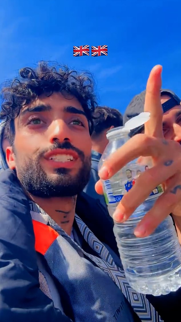 The migrant was with a group of around 30 men seen cheering, waving and holding out their hands in thanks to the French boat which travels right next to them to hand over the water