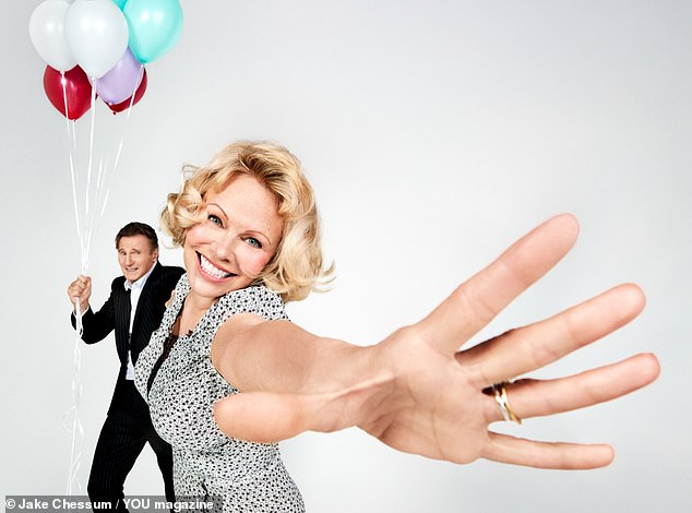 Liam wears: suit, Dolce & Gabbana. Shirt, Armani. Pamela wears: dress, Nina Ricci