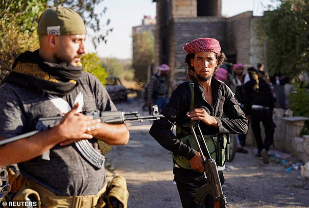 Bedouin fighters stand together with their weapons, after sectarian clashes escalated on Saturday in Syria's predominantly Druze region