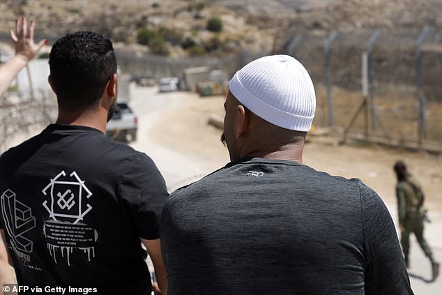 Members of the Druze community at buffer zone as they wait for a chance to see relatives on the Syrian side near the Druze village of Majdal Shams in the Israel-annexed Golan Heights