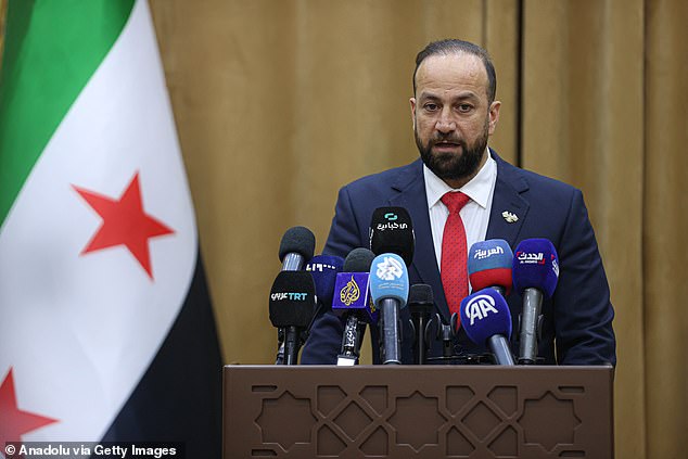 Syrian Information Minister Hamza al-Mustafa holds a press conference in Syria on July 19