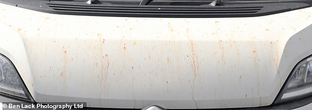 Pictured: Blood-coloured stains on a van parked at a mechanic nearby to the plant. Locals say the by-products billowing from the factory chimneys are creating a 'film' over their vehicles