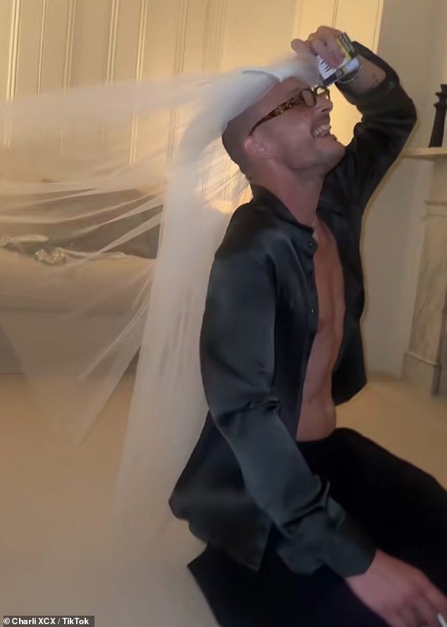 Larking around George modelled his new wife's veil while puffing on a cigarette and flashing his buff physique beneath an open shirt