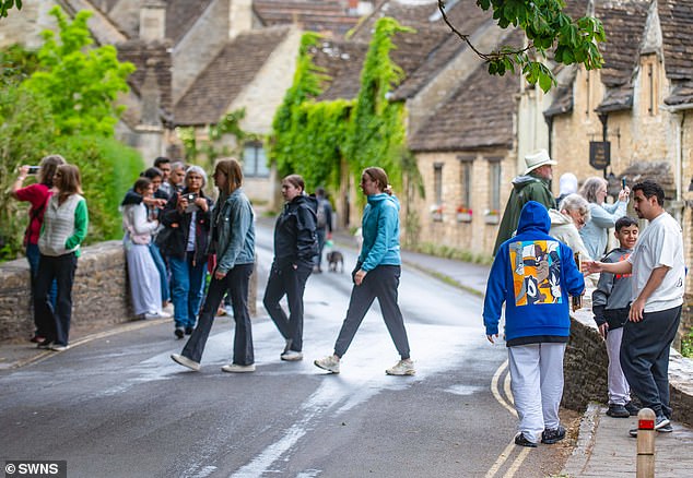 Locals in Castle Combe, dubbed 'one of the most beautiful locations in the UK', have claimed tourists are ruining the picturesque village in the Cotswolds (Tourists pictured in 2023)