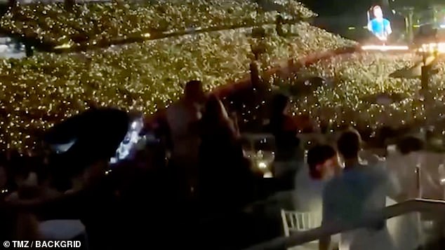 Filmed from behind their seats, the footage shows Byron leaning in to kiss Cabot as the duo hug tightly