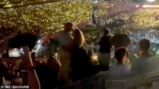 They can be seen swaying and embracing in front of thousands of fans as the stadium lit up with phone lights