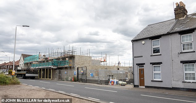 Work has been started to rebuild a row of properties that were gutted in the fire (Pictured: Construction work today)