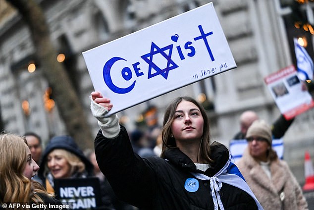 Pictured: A protester holds reading "Coexist" during a demonstration in central London, on November 26, 2023