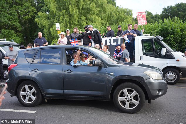 Cars beeped their horns as they drove by, waving Union Jack flags as protestors cheered
