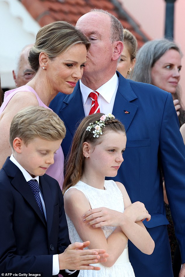In one image the Prince could be seen leaning over to plant a sweet peck on his wife's face
