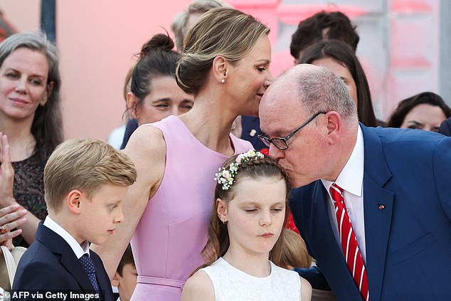 In one picture the doting father affectionately kissed his young daughter
