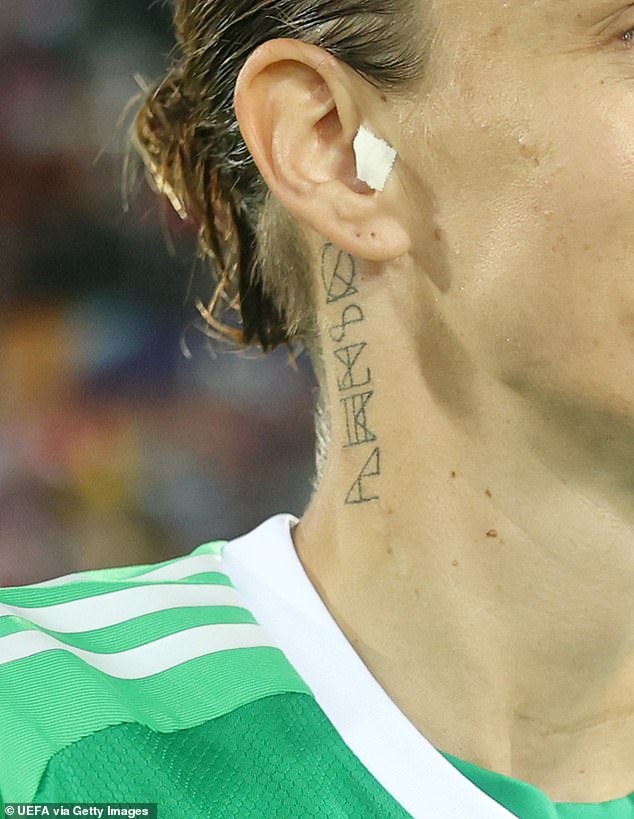 The footballer told German publication Bild that scars from surgery for the disease 'bothered' her and she decided to get a symbolic tattoo under her right ear to hide them