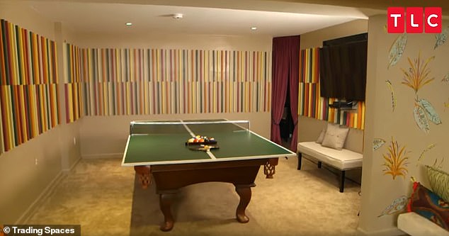 The large room had been zoned into several areas, including a dining area, sitting room, bar and a spot for the pool table - where wooden cues covered the wall (pictured)