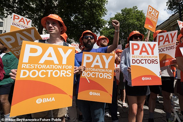 It says further reserves worth tens of millions can be tapped into to wreak chaos throughout the summer. Pictured: Junior doctors take part in a rally outside Downing Street over pay just last year