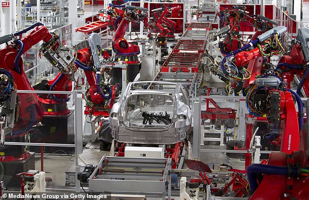 Robots assemble Teslas at the firm's auto plant in Fremont, California
