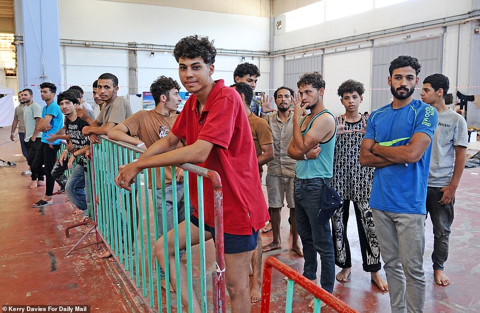 Inside the warehouse camp, the smell of unwashed men and urine was overbearing