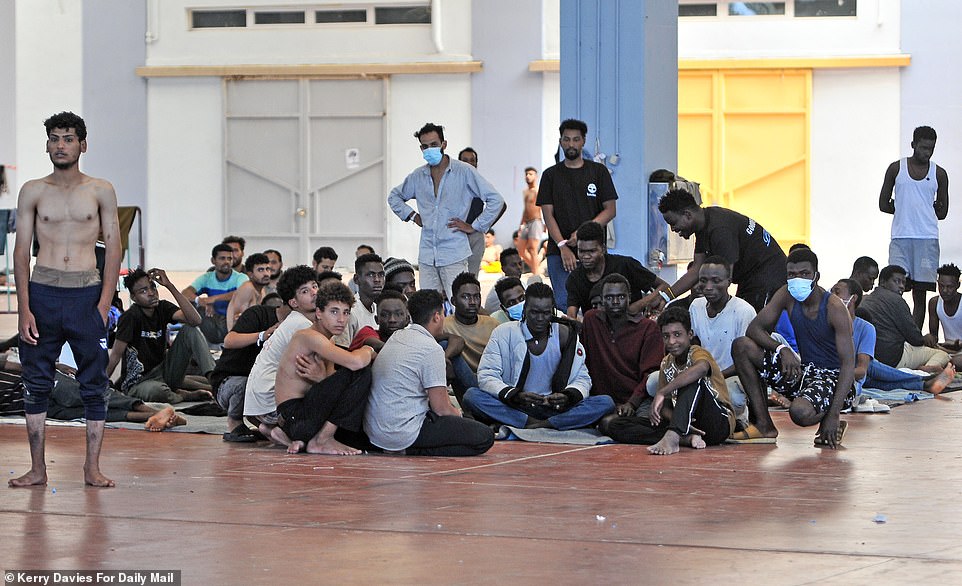 The migrants shouted for help, with some putting up their hands to show ten fingers, the number of days they have been incarcerated here