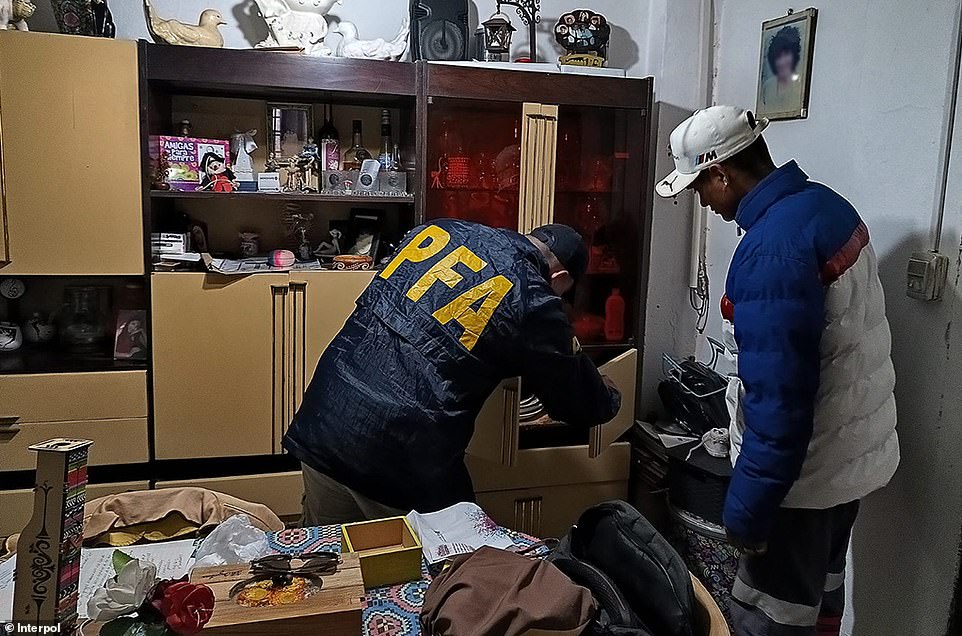 Around 300 people have been prosecuted and 39 juveniles given cautions. Pictured: Police investigating the Black Axe gang