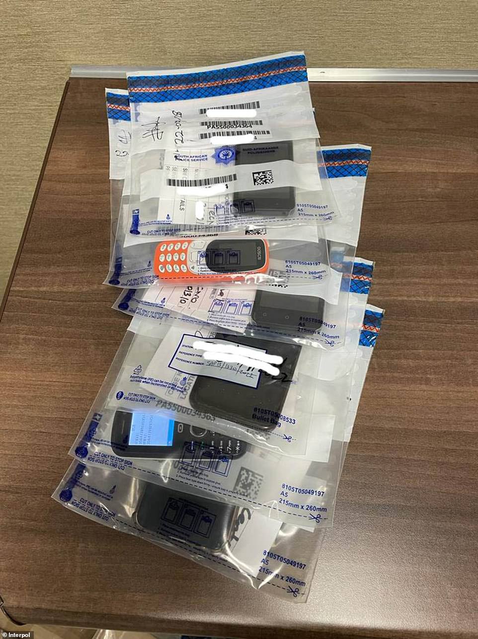 While leaders claim Black Axe is a rogue breakaway group, international law enforcement agencies describe it as the 'criminal wing' of the NBM and evidence shows its illicit funds are funnelled into the group. Pictured: Items seized during Black Gang investigations