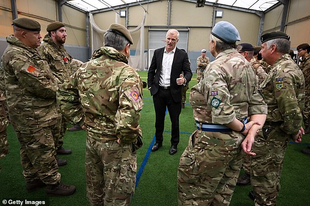 Mr Carns (pictured speaking with British Army personnel in October last year), a former Royal Marines officer who served with some of the Triples in Afghanistan, said it was 'great to sit down with some of my Afghan friends'