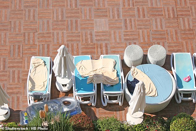 Even though most resorts prohibit the reserving of sunbeds, it's common to see them draped with towels while holidaymakers are off having their breakfast – a travel etiquette no-no. Pictured: File photo