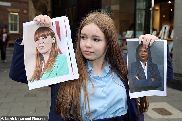 Oliva is seen holding up pictures of Deputy Prime Minister Angela Rayner and Tory leader Kemi Badenoch. She admitted she was 'not really into politics', but knew that Keir Starmer is the Prime Minister