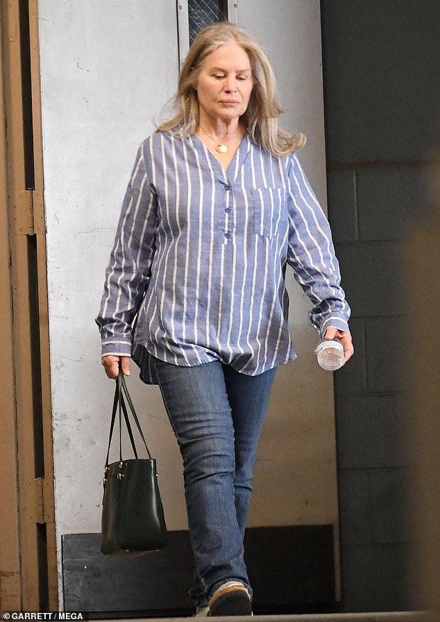 The actress paired a blue, pinstriped button-down blouse with straight-leg jeans and white, leather sandals. With a fresh blowout, she flipped and flaunted her trademark bouncy waves after shopping at a HomeGoods store in Los Angeles