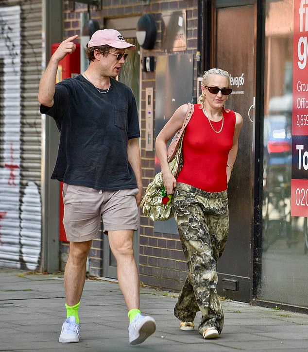 Happy Valley star Norton was casually dressed in a black T-shirt, khaki shorts, neon green socks, trainers and cap, while Ms Huddart wore a red top with loose trousers