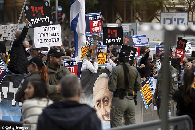 Supporters of Israeli Prime Minister Benjamin Netanyahu hold up signs outside Tel Aviv's court as Netanyahu testifies in a corruption trial on December 10, 2024