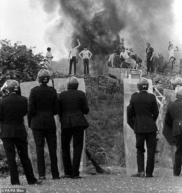 Police with riot shields face picketers during the confrontation on June 18, 1984