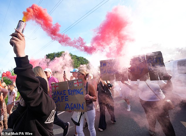 Protesters took to the streets for another day - with marchers seen holding red smoke flares aloft as demonstrators displayed signs behind them