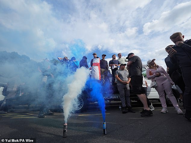 Blue and white smoke bombs were let off outside the hotel in Epping as protesters gathered
