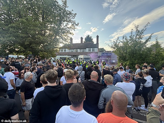 Crowds were seen facing police who lined up outside the hotel as smoke bombs were launched