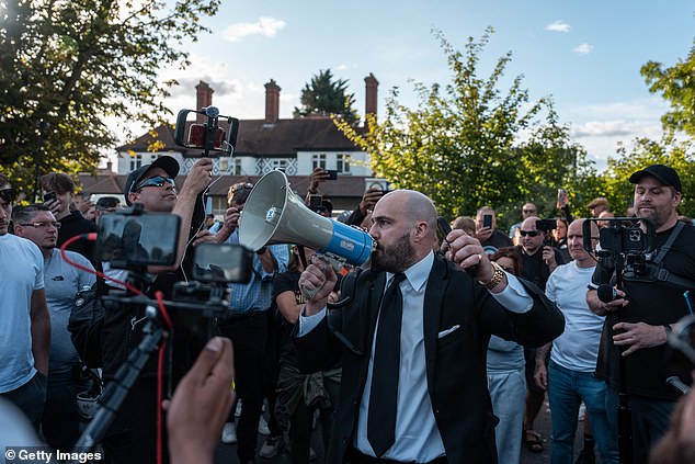 UKIP politician Nick Tenconi led chants outside the hotel as he called on protesters to gather outside 'every week'